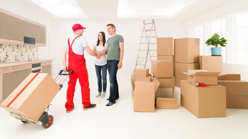 Packed boxes and furniture ready for flat removals in West Drayton